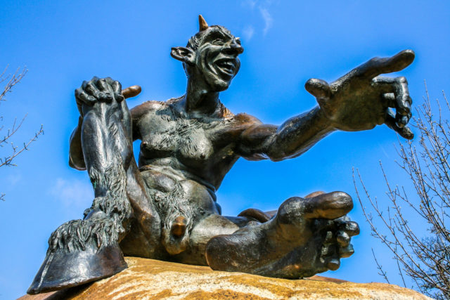 Teufel Energetisches Feng Shui, lachender Teufel mit Huf, Penis, Bronzefigur, Hexentanzplatz, blauer Himmel
